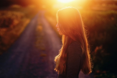 beautiful-woman-with-long-hair-silhouette-watching-flower-at-sunset
